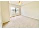 Bedroom with a window, carpet, and neutral colored walls at 2605 Gala S Rd # 103, Kissimmee, FL 34746