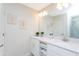 Bright bathroom featuring dual sinks, white cabinets, and decorative wall art for a modern aesthetic at 3121 Paradox Cir # 203, Kissimmee, FL 34746