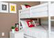 A charming bedroom featuring a bunk bed with bright, playful decor and bedside table at 3121 Paradox Cir # 203, Kissimmee, FL 34746