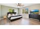 Bedroom with light wood floors, accent wall, ceiling fan, and natural light through dual windows at 33 Sunset Dr, Debary, FL 32713