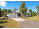 Well-maintained single-story home featuring a new driveway, attached garage, and lush front yard at 33 Sunset Dr, Debary, FL 32713