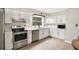 Modern kitchen with stainless steel appliances, quartz countertops, and white cabinets at 33 Sunset Dr, Debary, FL 32713