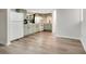 Spacious kitchen featuring light green cabinets, white appliances, and wood-look flooring at 33 Sunset Dr, Debary, FL 32713