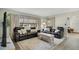 Sunlit living room with modern furniture, and large windows with contemporary flooring at 33 Sunset Dr, Debary, FL 32713