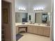 Well-lit bathroom featuring dual vanities, ample storage space, and elegant mirrors at 3315 Newbliss Cir, Ormond Beach, FL 32174