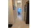 Long hallway with tile flooring, neutral walls, and access to multiple rooms at 3315 Newbliss Cir, Ormond Beach, FL 32174