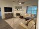 Well-lit living room with a fireplace, comfortable seating, and modern decor at 3315 Newbliss Cir, Ormond Beach, FL 32174