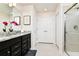 Bathroom featuring granite countertops, tiled shower with glass door, and ample storage space at 3373 Lilac Way, Davenport, FL 33897