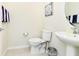 Clean and bright powder room features a pedestal sink and neutral decor at 3373 Lilac Way, Davenport, FL 33897