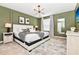 Comfortable bedroom features elegant sage walls, modern decor, patterned rug, and a bright, stylish lamp at 3373 Lilac Way, Davenport, FL 33897