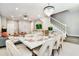 Inviting dining area with elegant seating, a chandelier, and an open connection to the living room and staircase at 3373 Lilac Way, Davenport, FL 33897