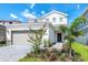 Charming two-story home with a two-car garage and manicured front yard landscaping at 3373 Lilac Way, Davenport, FL 33897