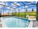 Sparkling screened-in pool with a colorful unicorn float and grassy lawn at 3373 Lilac Way, Davenport, FL 33897