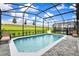 Inviting screened-in pool with lounge chairs and a view of the expansive green lawn at 3373 Lilac Way, Davenport, FL 33897