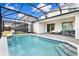 Sparkling screened-in pool with patio furniture and adjacent outdoor living spaces at 3373 Lilac Way, Davenport, FL 33897