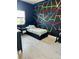 Modern bedroom with geometric tape design on a black accent wall at 36104 Emeralda Ave, Leesburg, FL 34788