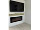 Modern electric fireplace set in a custom wall feature with a floating mantel at 36104 Emeralda Ave, Leesburg, FL 34788