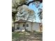 Front exterior view showcasing horizontal siding, porch swing and privacy fence at 36104 Emeralda Ave, Leesburg, FL 34788