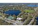 Aerial view of a community center showcasing tennis courts, lakes, and parking at 382 Frances Ave, Casselberry, FL 32707