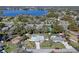 Aerial view of a home with a pool near a lake highlighting the home's setting within its neighborhood at 382 Frances Ave, Casselberry, FL 32707