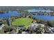 Aerial view of a community park featuring a sports field, surrounded by lakes and trees, ideal for outdoor recreation at 382 Frances Ave, Casselberry, FL 32707