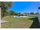 Extensive backyard featuring a pool, covered patio, shed, well maintained lawn and white fence at 382 Frances Ave, Casselberry, FL 32707