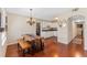 Open dining room with wood floors and table, connecting to the kitchen with white cabinets at 382 Frances Ave, Casselberry, FL 32707