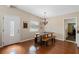 Bright dining room features hardwood floors, wood table with benches, and decorative light fixture at 382 Frances Ave, Casselberry, FL 32707