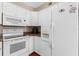 Bright kitchen features white appliances, light countertops and white cabinetry at 382 Frances Ave, Casselberry, FL 32707