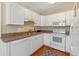 Kitchen with ample white cabinetry, modern appliances, and laminate countertops at 382 Frances Ave, Casselberry, FL 32707