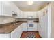 Well-lit kitchen featuring white appliances, light countertops and hardwood floors at 382 Frances Ave, Casselberry, FL 32707