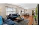 Cozy living room with hardwood floors, blue sofas, and an adjacent dining area at 382 Frances Ave, Casselberry, FL 32707