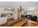 Open-concept living space featuring hardwood floors, a chandelier, and seamless flow to the kitchen at 382 Frances Ave, Casselberry, FL 32707