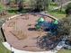 Aerial view of community playground with slides, swings, and climbing structures, surrounded by sidewalks at 382 Frances Ave, Casselberry, FL 32707