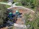 Aerial view of community playground featuring slides, swings and climbing equipment, surrounded by mature trees at 382 Frances Ave, Casselberry, FL 32707