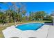 Inviting backyard pool with a concrete deck, storage shed, and well maintained landscaping at 382 Frances Ave, Casselberry, FL 32707