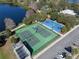 Aerial view of the community tennis and basketball courts, located near a lake and parking area at 382 Frances Ave, Casselberry, FL 32707