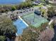 Aerial view of the community tennis and basketball courts with parking, adjacent to a road and green space at 382 Frances Ave, Casselberry, FL 32707