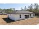 Exterior view of the home features a sliding glass door, and neutral paint at 41915 Aspen St, Eustis, FL 32736