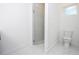 Bright, all-white bathroom with a modern toilet and walk-in glass shower at 41915 Aspen St, Eustis, FL 32736