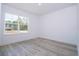 Minimalist bedroom with a large window offering a view of the outdoors at 41915 Aspen St, Eustis, FL 32736