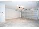 Large, clean garage featuring concrete floors, white block walls, an automatic door, and overhead lighting at 41915 Aspen St, Eustis, FL 32736