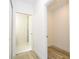 Hallway featuring luxury vinyl plank flooring, white walls, and doorways to a bathroom and closet at 41915 Aspen St, Eustis, FL 32736