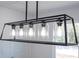 Modern linear pendant lighting fixture featuring geometric black framework and clear glass shades at 41915 Aspen St, Eustis, FL 32736