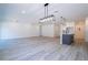 Open-concept living room and kitchen area featuring wood-look floors and modern lighting fixtures at 41915 Aspen St, Eustis, FL 32736