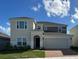 Two-story home featuring a two-car garage, neutral colors, and a well-manicured lawn at 4229 Deleon St, Haines City, FL 33844