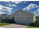 Single story home with gray exterior, gray stone accent and two car garage at 4317 Deleon St, Haines City, FL 33844