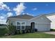 Single story home with gray exterior, gray stone accent and two car garage at 4317 Deleon St, Haines City, FL 33844