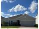 Single story home with gray exterior, gray stone accent and two car garage at 4317 Deleon St, Haines City, FL 33844