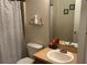 Bathroom featuring a toilet, sink, vanity mirror and a shower with polka dot curtain at 504 Delido Way, Kissimmee, FL 34758